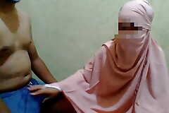 a woman wearing a hijab does a handjob to her maid